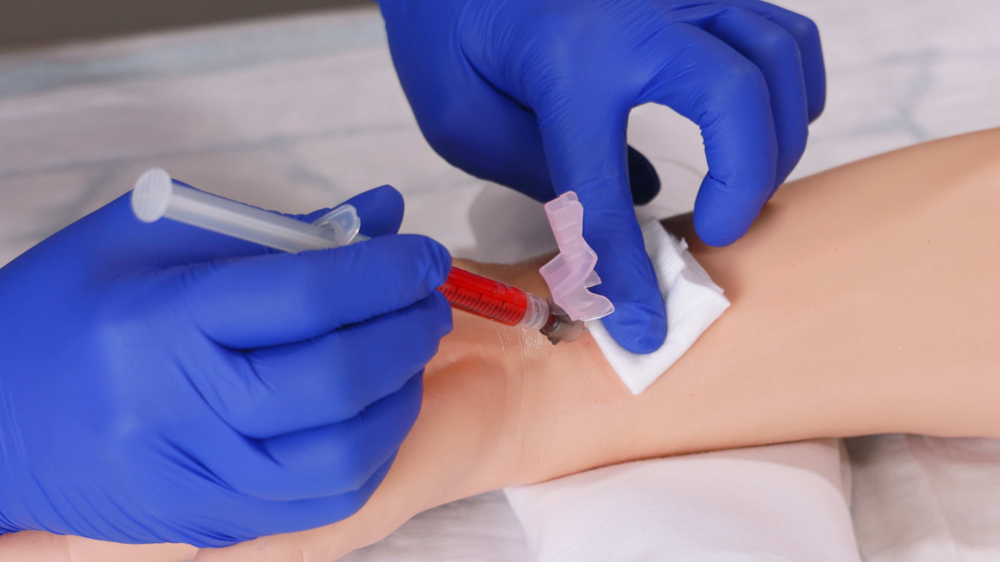 A task trainer is being use to demonstrate blood taken from an artery for the purpose of sampling. Demonstration of blood taken for Arterial Blood Gas Sampling